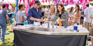 Portable sink at an outdoor event with vibrant decor.