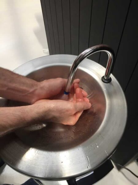 Portable hot water handwash sink.