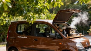 Aixam Mega 600D coffee van serving hot drinks outdoors.