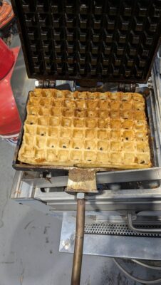 Golden Belgian waffle cooked on a Fracino MULTI LPG waffle maker for mobile catering